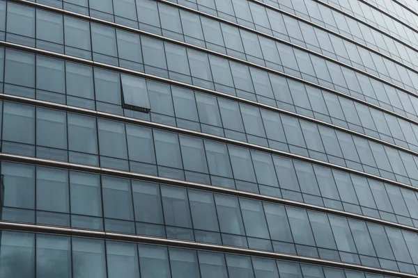 stock image An intriguing abstract composition captures a glass facade with one window open, inviting curiosity and creating a sense of mystery and possibility.