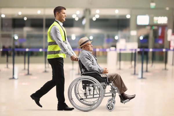 Filme Perfil Completo Trabalhador Aeroporto Empurrando Homem Idoso Uma Cadeira — Fotografia de Stock