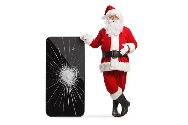 Święty Mikołaj Opierając Się Smartfonie Pękniętym Ekranem Białym Tle — Zdjęcie stockowe