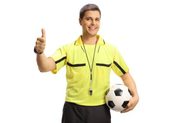 Cheerful football referee holding a ball and gesturing thumbs up isolated on white background clipart