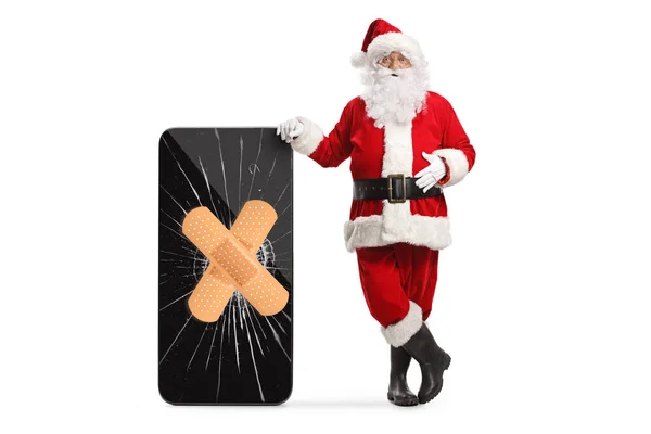 Santa Claus Ακουμπά Ένα Smartphone Μια Σπασμένη Οθόνη Σταθερό Επίδεσμο — Φωτογραφία Αρχείου