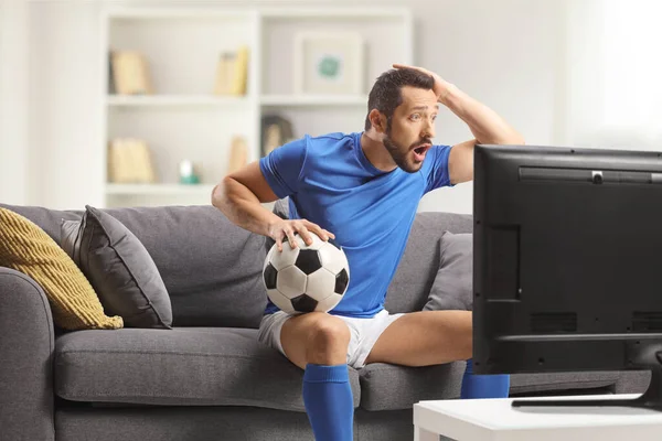 Surprised Football Player Watching Football Match Television Home Holding His — Stock Photo, Image