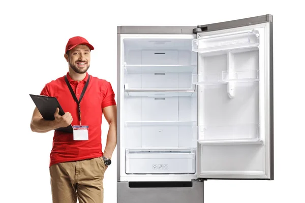 Чоловік Помічник Магазину Спирається Холодильник Тримає Буфер Обміну Ізольовано Білому — стокове фото