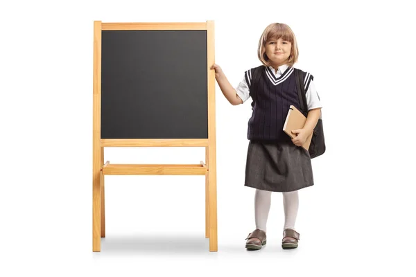 Little Girl School Uniform Carrying Backpack Standing Next Blackboard Isolated — Stock Photo, Image