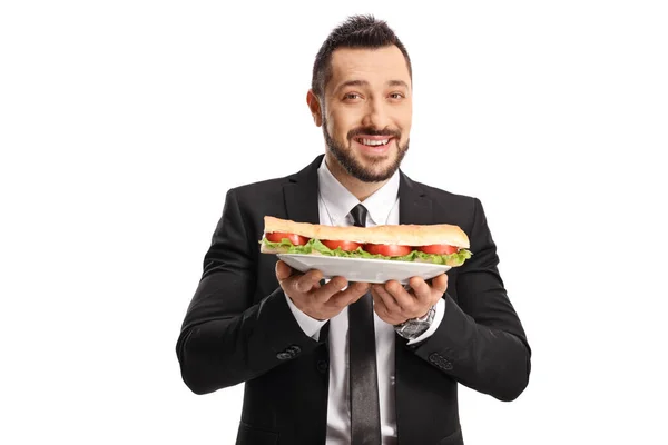 白地に隔離された皿の上にサンドイッチを持っているビジネスマン — ストック写真