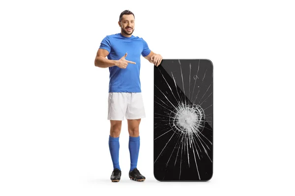 Full Length Portrait Football Player Pointing Big Smartphone Broken Screen — Stock Photo, Image