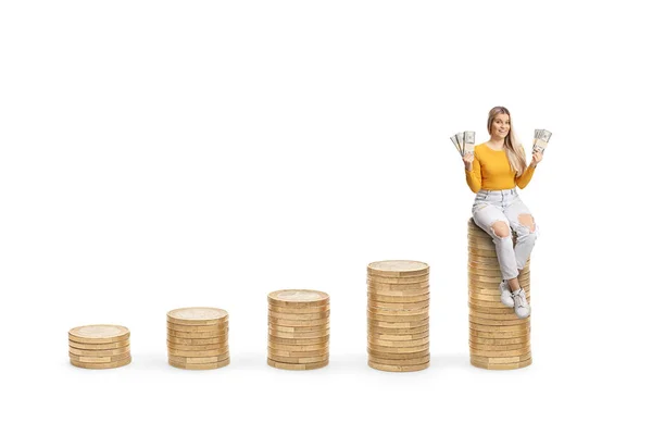 Young Female Sitting Highest Pile Coins Holding Banknotes Isolated White — Stock Photo, Image