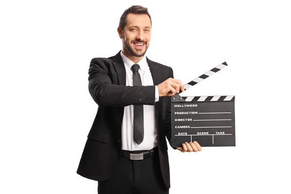身穿西服打领带的男人拿着一块被白色背景隔离的电影胶片夹板 — 图库照片