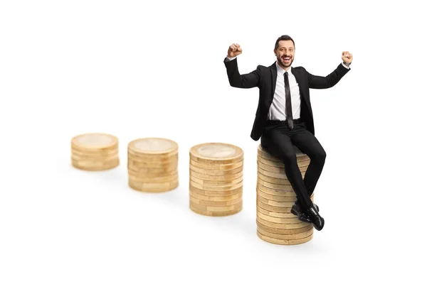 Businessman Seated Top Pile Coins Gesturing Success Isolated White Backgroun — Stock Photo, Image