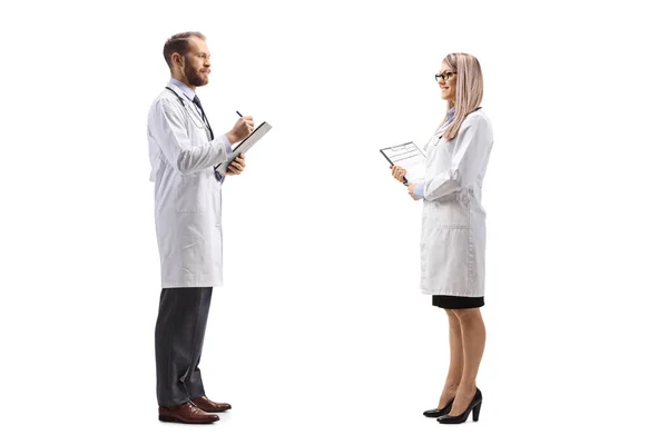 Doctor Talking Female Colleague Writing Document Isolated White Background — Stock Photo, Image