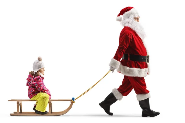 用白色背景隔离的木制雪橇拉着一个孩子的桑塔爪的全长轮廓镜头 — 图库照片