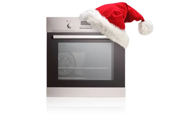 Studioaufnahme Eines Elektrischen Ofens Mit Weihnachtsmann Hut Auf Weißem Hintergrund — Stockfoto