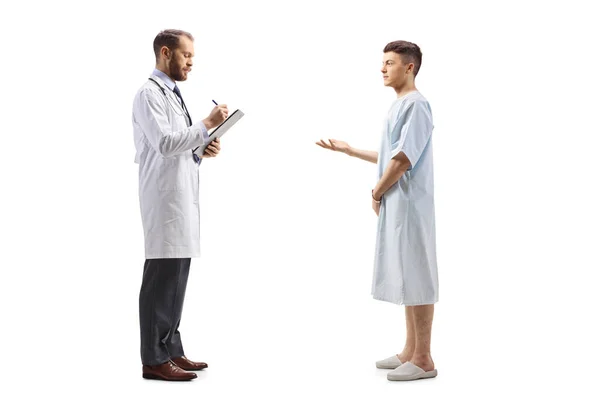 一名男医生和一名身穿医院长袍的年轻男病人站在那里 在白色背景下孤立无援地交谈的全景照片 — 图库照片