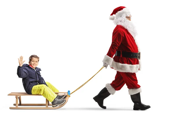 Full Length Profile Shot Santa Claus Τραβώντας Ένα Αγόρι Ένα — Φωτογραφία Αρχείου