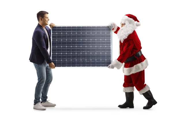 Фотография Молодого Человека Санта Клауса Несущего Солнечную Панель Белом Фоне — стоковое фото