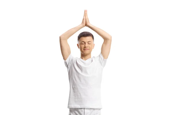Ung Man Stående Och Utövar Yoga Med Slutna Ögon Isolerade — Stockfoto