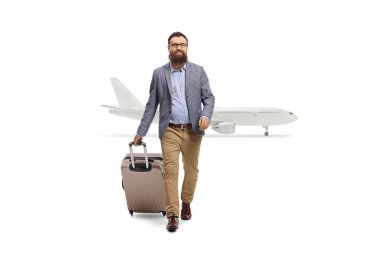Full length portrait of a man pulling a suitcase and getting off an airplane isolated on white background