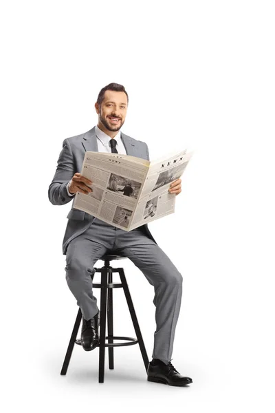 Young Professional Man Suit Sitting Chair Newspaper Smiling Camera Isolated — Stock Photo, Image
