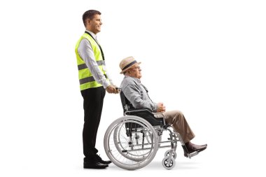 Full length profile shot of a guard standing with an elderly man in a wheelchair isolated on white background