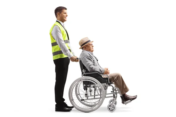 Full Length Profile Shot Guard Standing Elderly Man Wheelchair Isolated — Stok fotoğraf