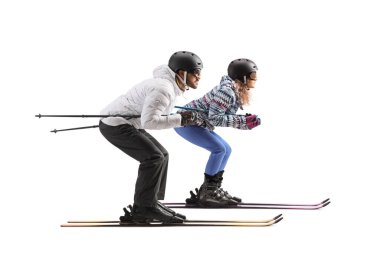 Full length profile shot of a man and woman skiing isolated on a white background