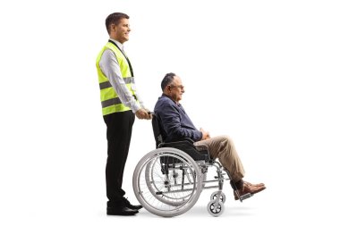 Full length profile shot of a special assitance worker with a passenger in a wheelchair isolated on white background
