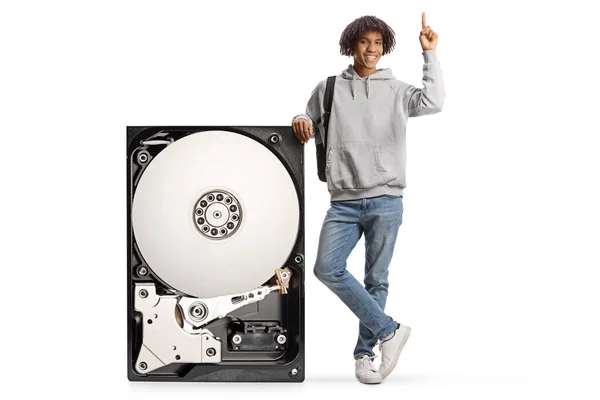 African American Young Man Leaning Big Hard Disk Pointing Isolated — Fotografia de Stock