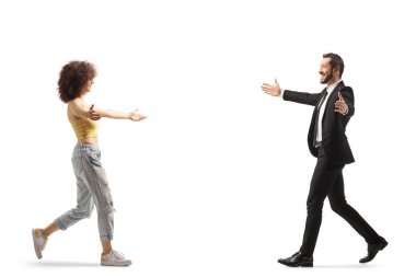 Full length profile shot of a casual young woman walking towards a businessman isolated on white background
