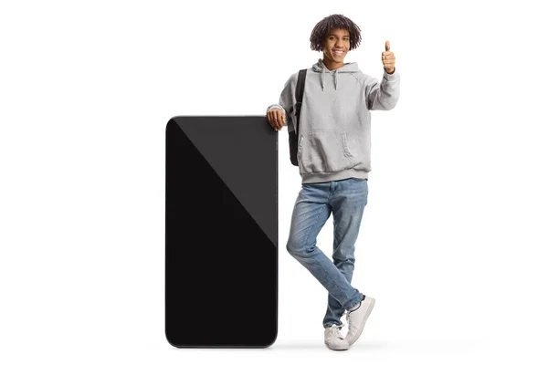 Young African American Student Leaning Big Mobile Phone Gesturing Thumbs — Photo