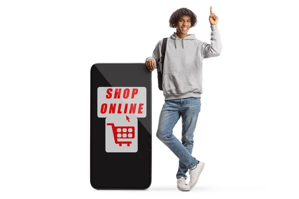 Young African American Male Backpack Leaning Big Mobile Phone Text — Stockfoto