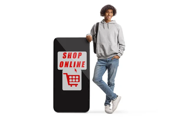 Young African American Male Smiling Leaning Big Mobile Phone Text — Stockfoto