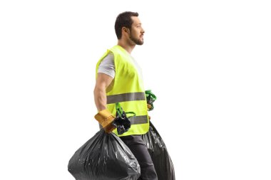 Profile shot of a waste collector walking and carrying bin bags isolated on white background