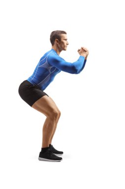 Full length profile shot of a muscular male athlete exercising isolated on white background