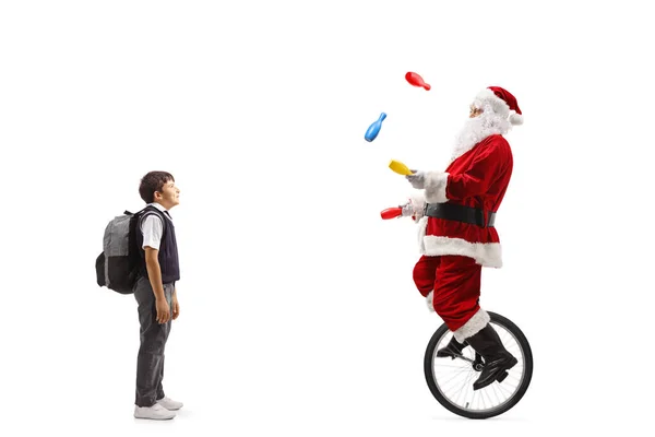 Boy Standing Watching Santa Claus Riding Mono Cycle Juggling Isolated — Fotografia de Stock