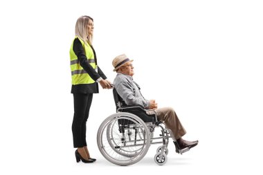 Female special assitance worker standing with a senior man in a wheelchair isolated on white background