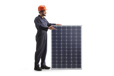 Worker in a uniform and helmet presenting a solar panel isolated on white background