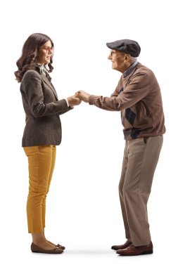 Full length profile shot of a young woman holding hands of an elderly man isolated on white background
