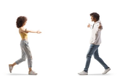 Young african american guy meeting a young caucasian woman isolated on white background