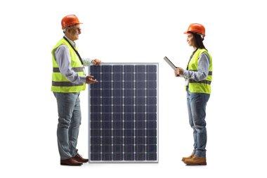 Mature male engineer with a solar panel talking to a young female engineer isolated on white background