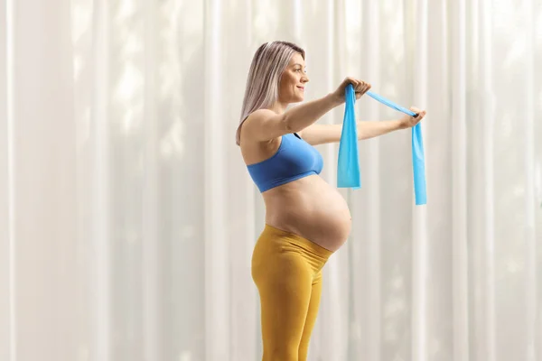 Profile Shot Pregnant Woman Exercising Stretching Band Home — Foto Stock