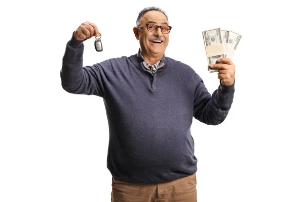 Smiling Mature Man Holding Car Key Stacks Money Isolated White — Stock fotografie