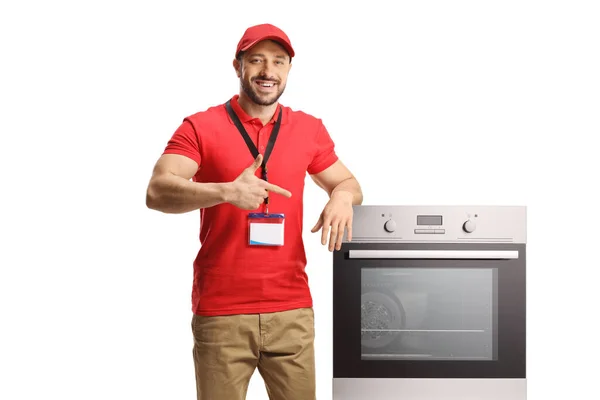 Shop Assistant Leaning Oven Pointing Isolated White Background — Stock Photo, Image