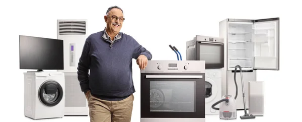 Smiling Mature Man Many Electrical Appliances Leaning Oven Isolated White — Stock Photo, Image