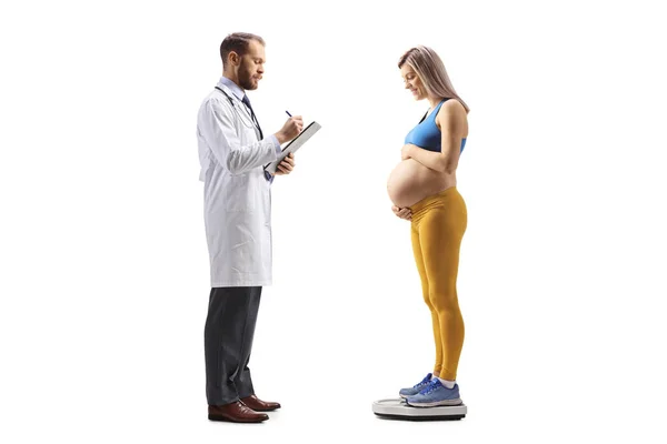Male Doctor Pregnant Woman Standing Weight Scale Isolated White Background — Stock Photo, Image