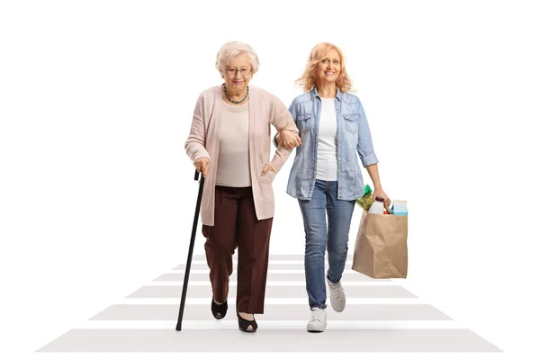 Woman Helping Elderly Lady Shopping Bags Pedestrian Crossing Isolated White — Stock Photo, Image