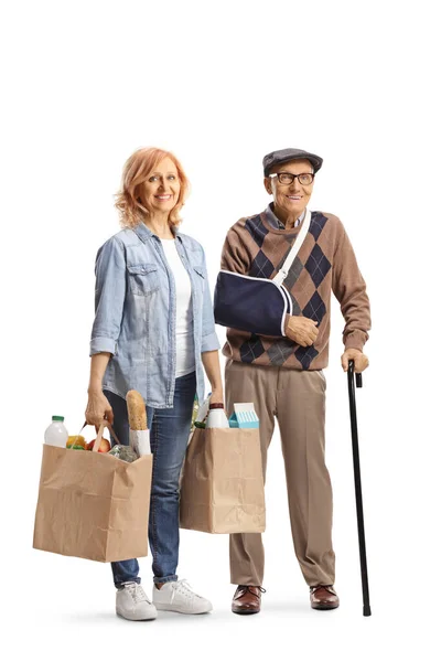 Woman Carrying Grocery Bags Elderly Man Broken Arm Isolated White — Stock Photo, Image