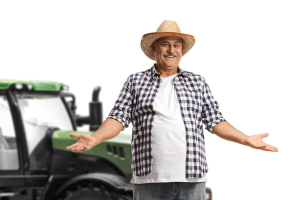 Smiling mature farmer with a straw hat gesturing with hands isolated on white background