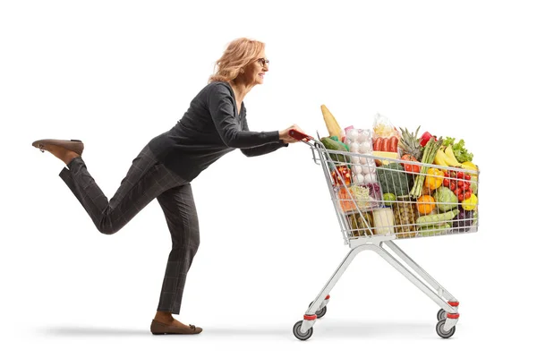 Full Length Profile Shot Mature Woman Running Shopping Cart Isolated — Zdjęcie stockowe