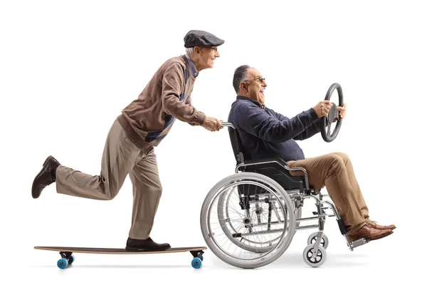 Starszy Mężczyzna Deskorolką Pchający Dojrzałego Mężczyznę Wózku Inwalidzkim Siedzącego Trzymającego — Zdjęcie stockowe