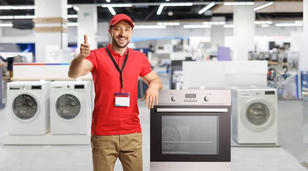 Salesman Electrical Appliances Smiling Leaning Oven Store Gesturing Thumbs — Stock Photo, Image